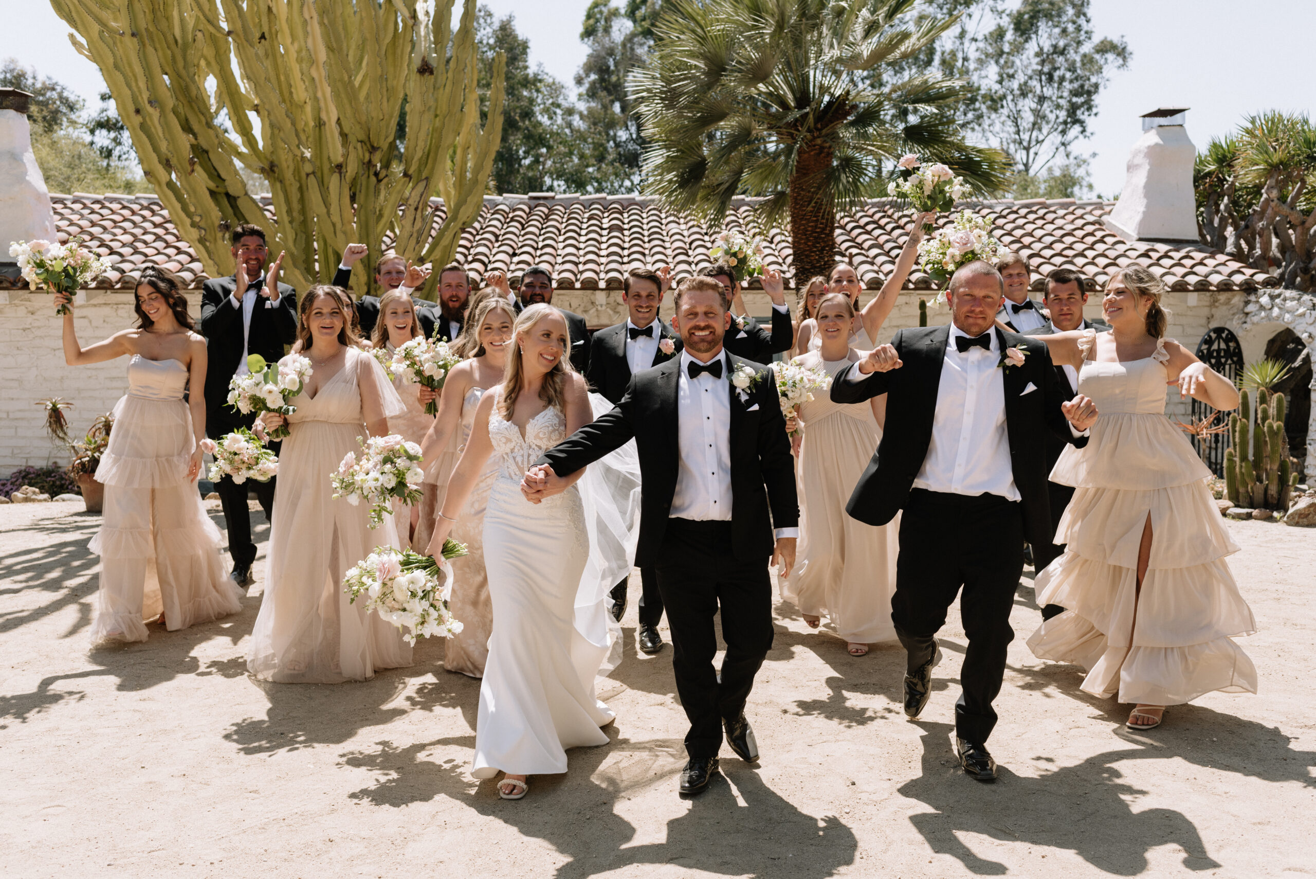 bride and groom cheer with wedding party at leo carrillo ranch