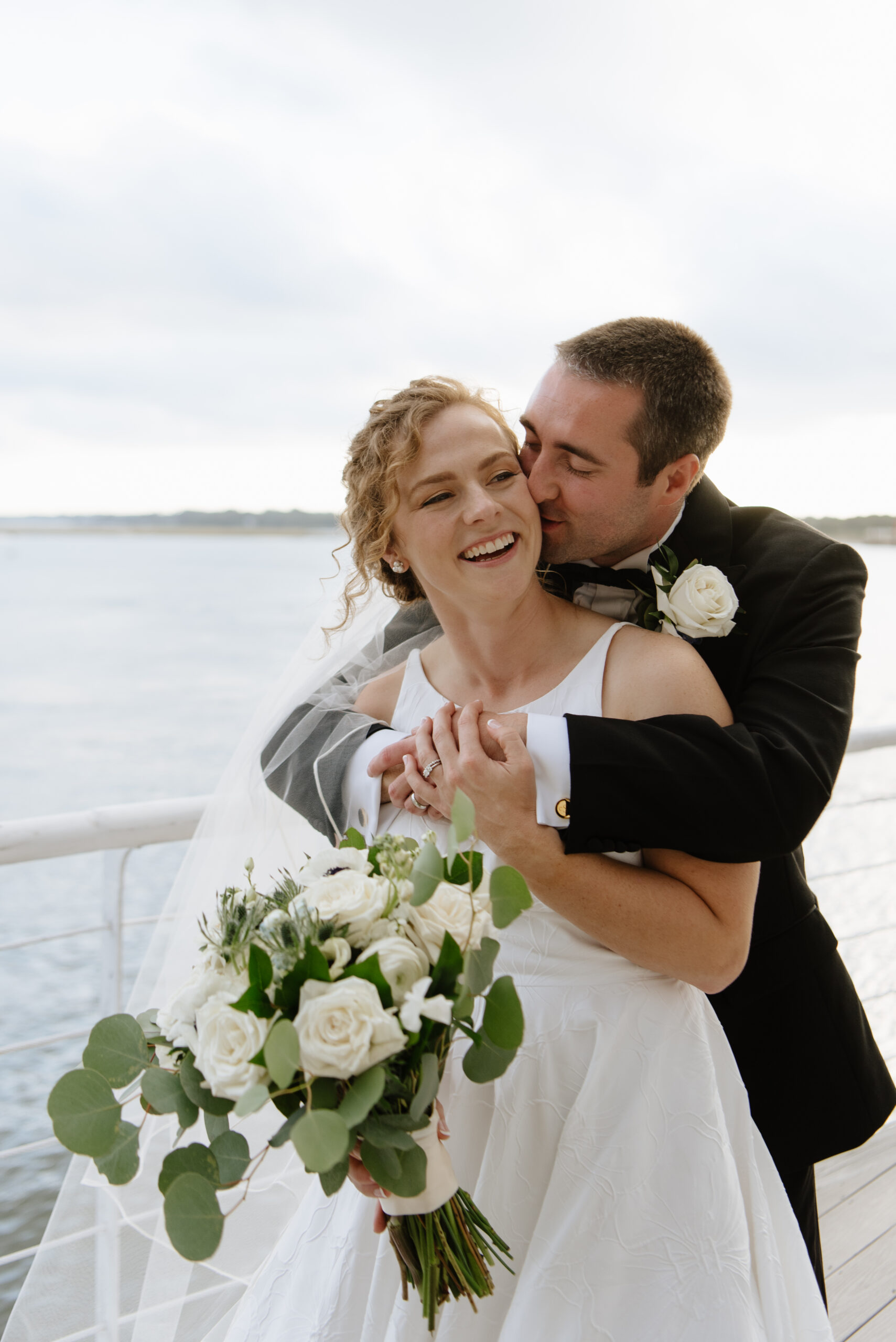 bride and groom laugh on their wedding day at lesner inn, virginia beach